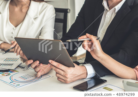 Businessman and businesswomen working in office. 48974299