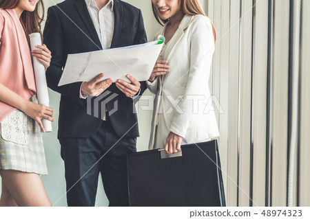 Businessman and businesswomen working in office. Businessman and businesswomen working in office. 48974323