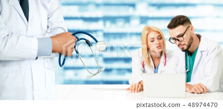 Doctor working in hospital with other doctors. Doctor working in hospital with other doctors. 48974470