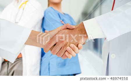 Doctor working in hospital with other doctors. 48974558
