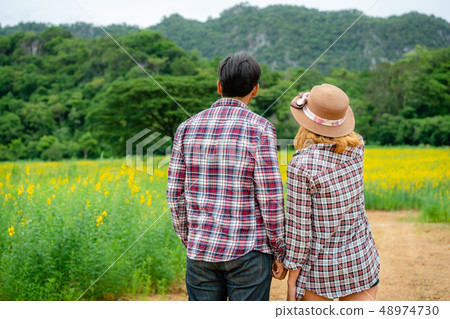 Happy couple take a romantic walk on the hills. Happy couple take a romantic walk on the hills. 48974730