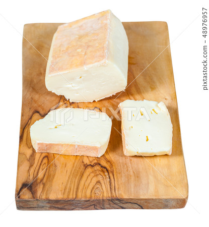 sliced italian Taleggio cheese on board isolated 48976957
