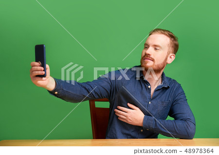 Handsome man taking selfie Handsome man taking selfie 48978364