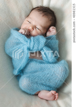 newborn baby sleeps wrapped in a blanket newborn baby sleeps wrapped in a blanket 48981315