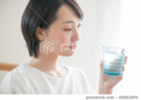 Young Japanese Woman Drinking Glass of Water Hydration 48982699
