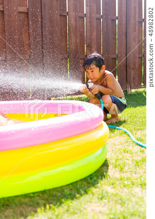 Garden lawn boy water play 48982802