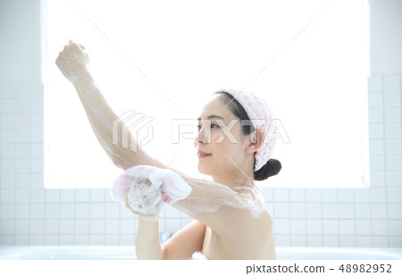 A woman taking a bath A woman taking a bath 48982952