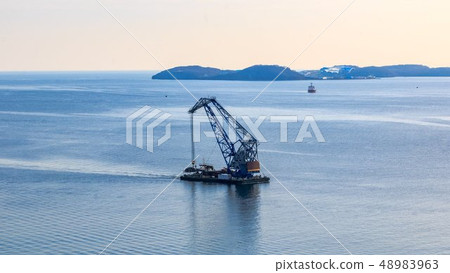 Floating crane on the background of the island Russian sails through the Bosphorus East Floating crane on the background of the island Russian sails through the Bosphorus East 48983963