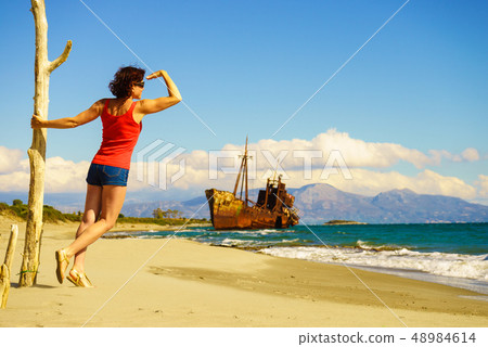 Tourist woman on beach enjoying vacation Tourist woman on beach enjoying vacation 48984614