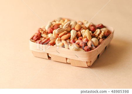 Dried fruits and nuts mix in a wooden bowl. Dried fruits and nuts mix in a wooden bowl. 48985398