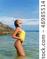 Beautiful girl posing on the beach in the hot sun 48985514
