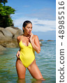 Beautiful girl posing on the beach in the hot sun 48985516