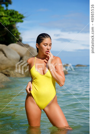 Beautiful girl posing on the beach in the hot sun 48985516