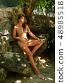 Beautiful girl posing on the beach in the hot sun 48985518