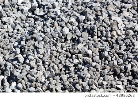 Stone crushed stone on the construction site as an abstract background Stone crushed stone on the construction site as an abstract background 48986268