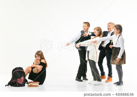 Little girl sitting alone on floor and suffering an act of bullying. 48986636