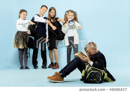Little boy sitting alone on floor and suffering an act of bullying. 48986837
