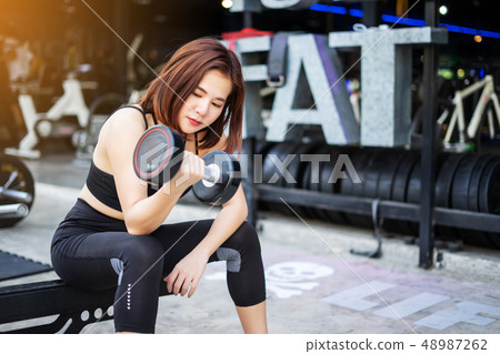young fitness woman execute exercise with young fitness woman execute exercise with 48987262