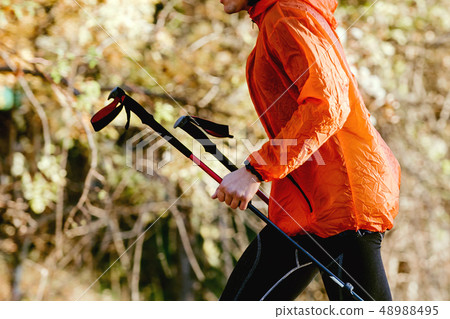 man skyrunner with trekking poles man skyrunner with trekking poles 48988495