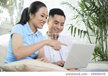 Couple ordering staff for new apartment Couple ordering staff for new apartment 48989439