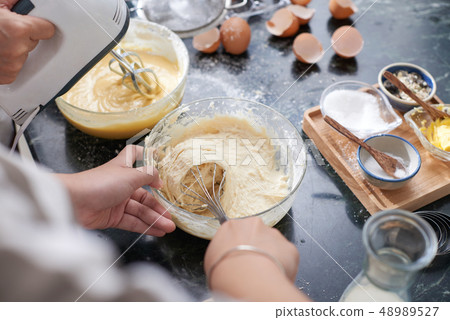 Woman making liquid dough Woman making liquid dough 48989527