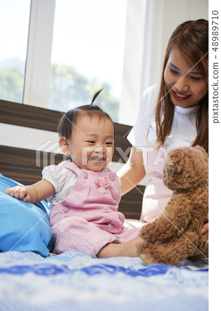 Baby excited to play with toy 48989710