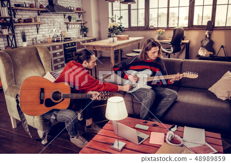 Two musicians watching music video and making their own cover Two musicians watching music video and making their own cover 48989859