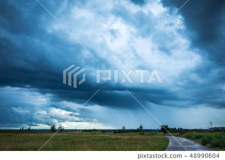 Image of dark Storm clouds in the field 48990604