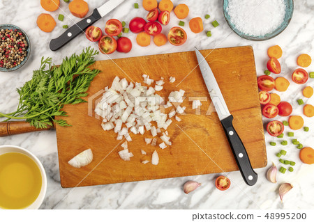 Prep time, or mise en place. An overhead photo of professional chef's knives, shot from above on a Prep time, or mise en place. An overhead photo of professional chef's knives, shot from above on a 48995200