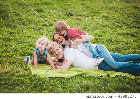 Happy family together in green park in summer 48995273