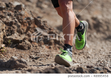 Trail running action close up of running shoes Trail running action close up of running shoes 48995458