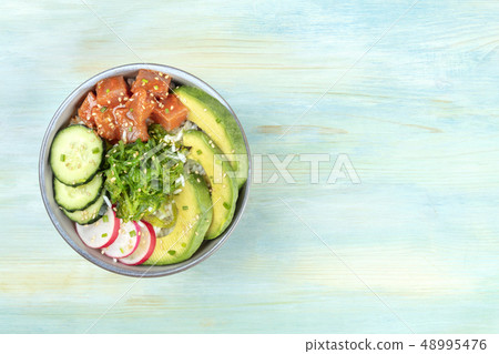 Hawaiian tuna poke salad on teal with copy space 48995476