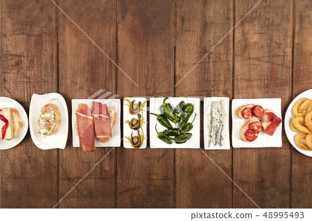 Spanish tapas food on dark background with place for text Spanish tapas food on dark background with place for text 48995493