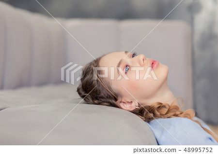 Frustrated blonde teenager being deep in thoughts Frustrated blonde teenager being deep in thoughts 48995752
