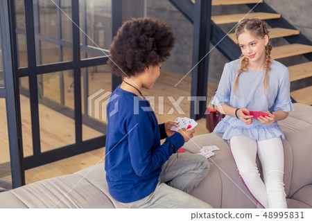Kind teenager checking his cards before game 48995831