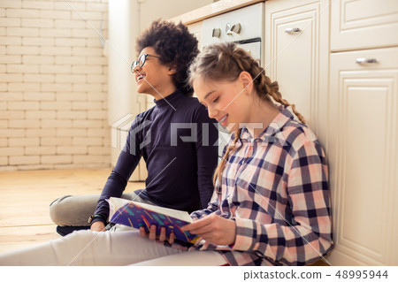 Charming blonde girl keeping smile on her face Charming blonde girl keeping smile on her face 48995944