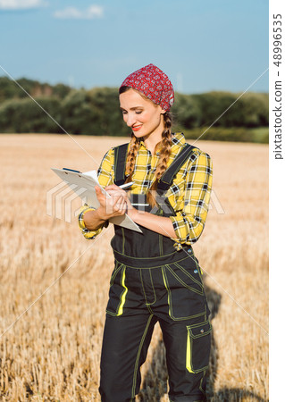 Farmer doing business administration on the field Farmer doing business administration on the field 48996535