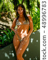 Beautiful girl posing on the beach in the hot sun 48996783