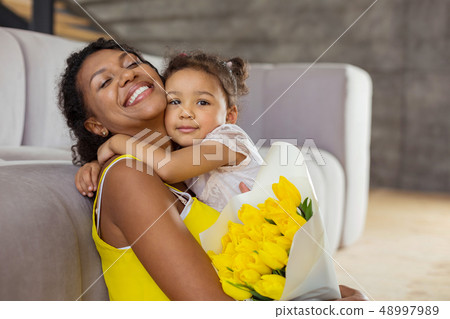 Attractive brunette girl caressing her young mother Attractive brunette girl caressing her young mother 48997989