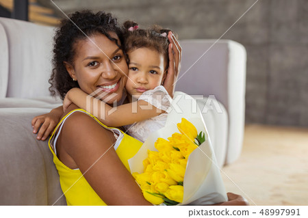 Kind international mommy embracing her little daughter Kind international mommy embracing her little daughter 48997991