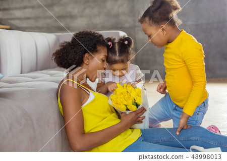 Emotional brunette females staring together at tulips 48998013