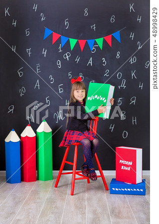 Cute school girl posing in studio shoot in school Cute school girl posing in studio shoot in school 48998429