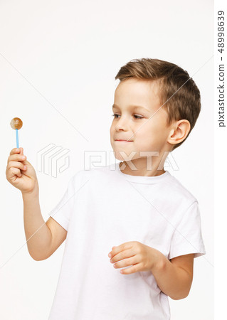 little boy with a lollipop on a white background little boy with a lollipop on a white background 48998639
