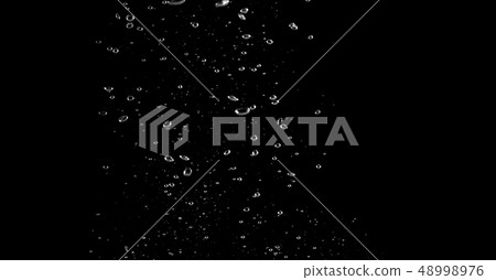 Blurry images of soda bubbles splashing in black 48998976