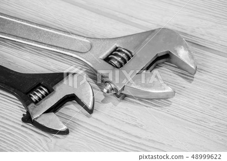 two adjustable wrenches on the table close up two adjustable wrenches on the table close up 48999622