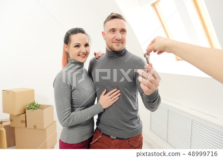 The seller gives customers the keys to the new apartment. 48999716