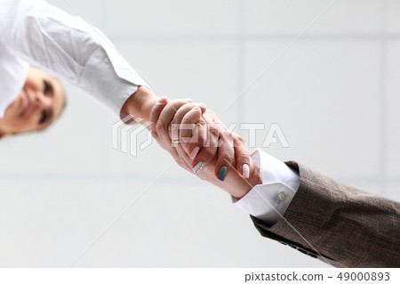 Man in suit and tie give hand as hello in office Man in suit and tie give hand as hello in office 49000893