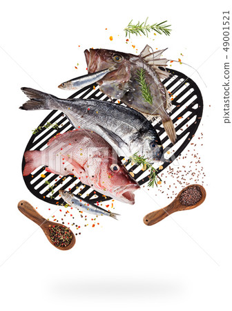 Flying raw sea fish with ingredients for cooking. Food preparation concept. Flying raw sea fish with ingredients for cooking. Food preparation concept. 49001521