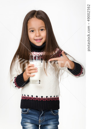 little child girl holding glass of milk on white background little child girl holding glass of milk on white background 49002562