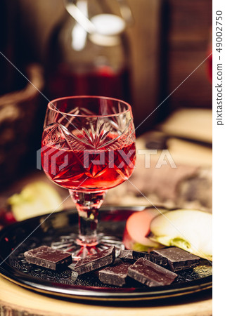Glass of homemade redcurrant nalivka with apple 49002750